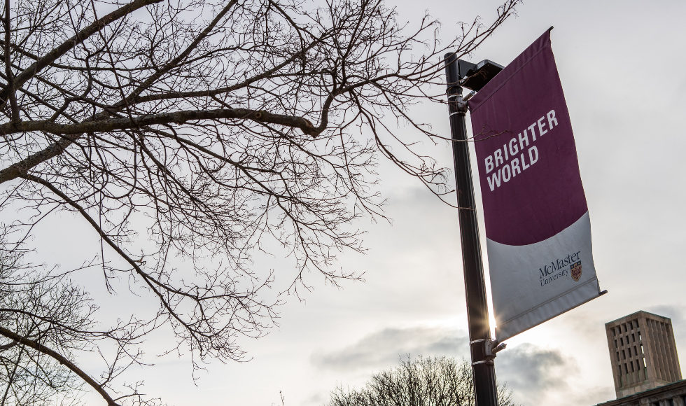 Photo of McMaster Brighter World banner from campus