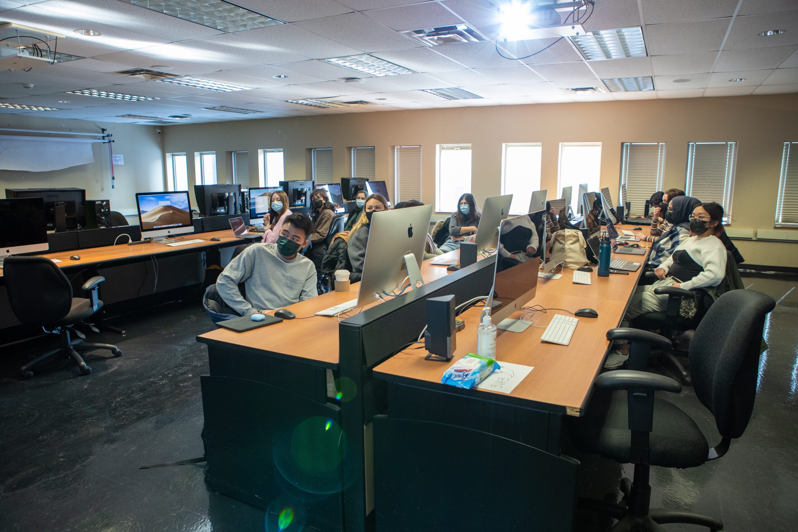 Wide shots of students sitting in computer lab.