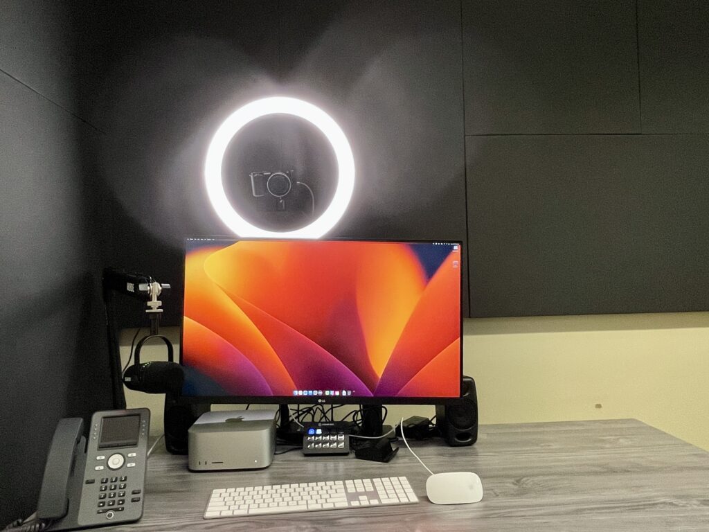 Ed Tech desk station with: a ring light, computer, keyboard and speaker.