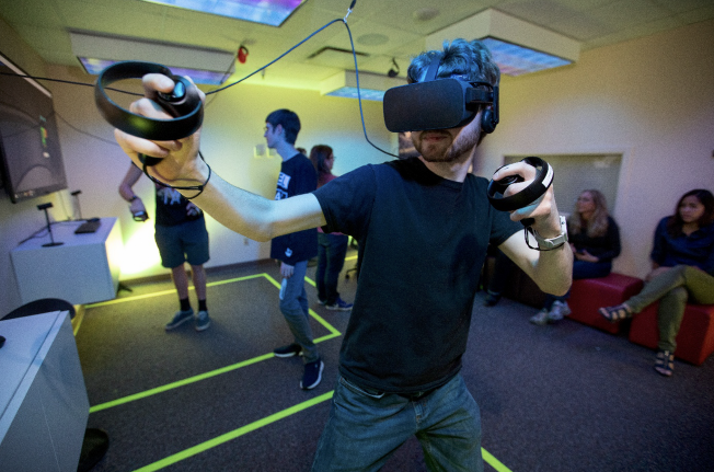 Student wearing VR glasses and a handheld controller